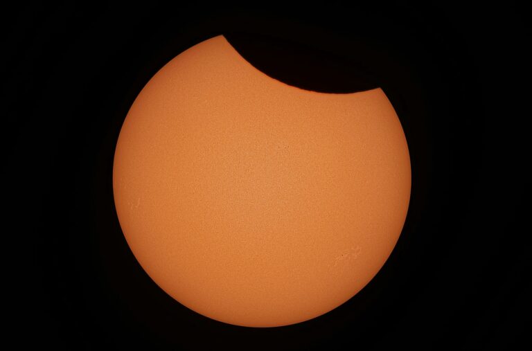 Capture of a partial solar eclipse with detailed solar surface in Dęblin, Poland.