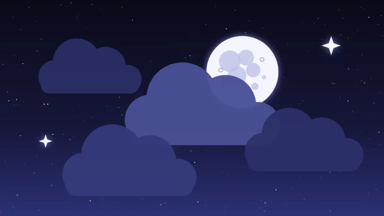 La Lune à demi cachée par des nuages dans un ciel étoilé